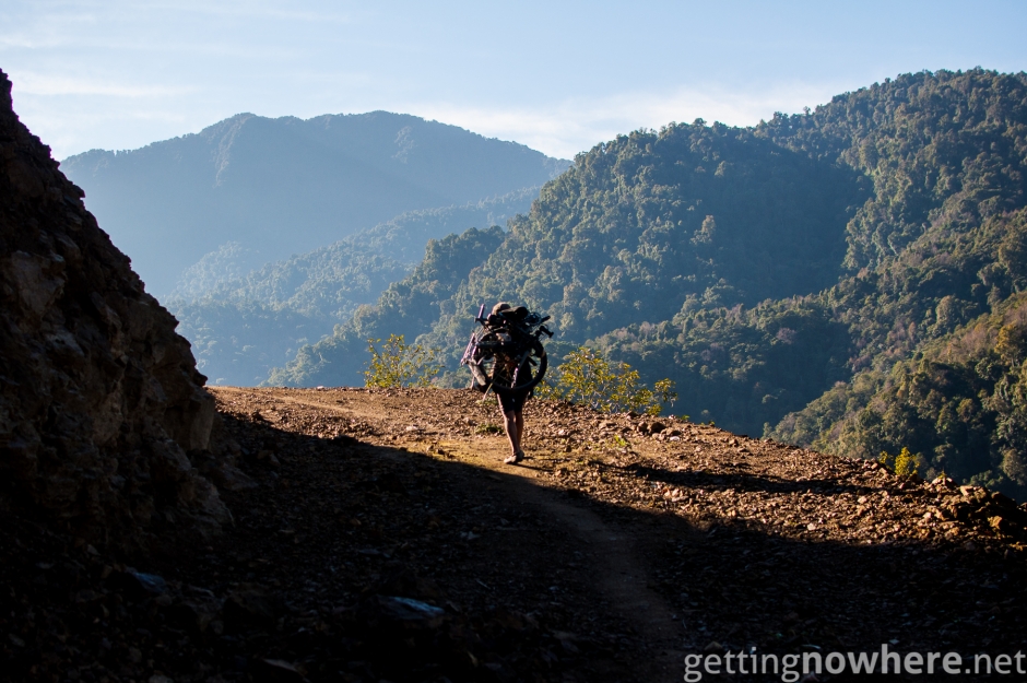 Carrying the bike on his back